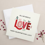 Romantic square card featuring red and pink lettering, greenery details, and Valentine’s greeting, displayed with white envelope — XOXOKristen.