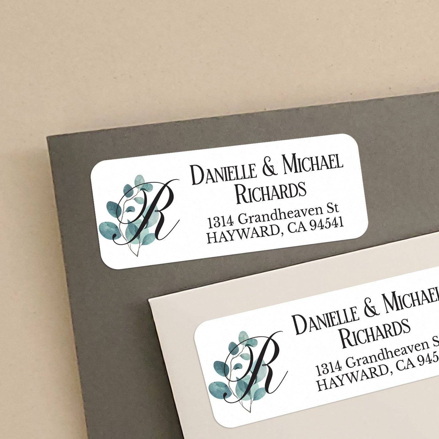 Personalized rectangular return address label with elegant black monogram accented by watercolor eucalyptus leaves on a white background - XOXOKristen