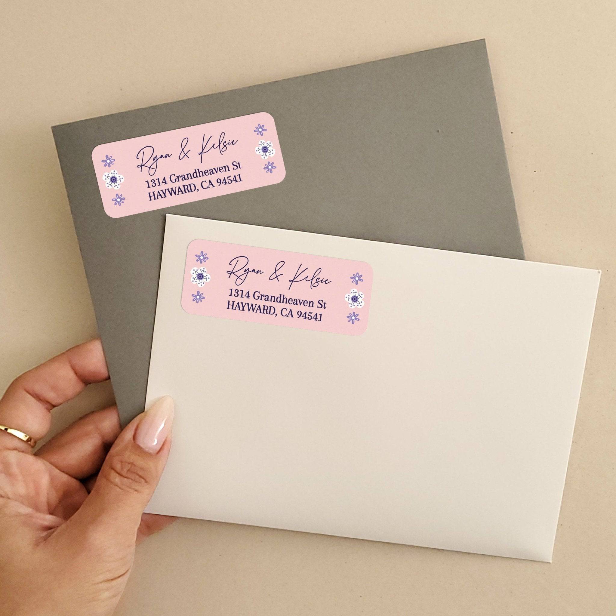 Personalized rectangular return address label with soft pink background, purple floral accents, and modern black script typography - XOXOKristen