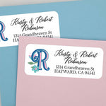 Elegant personalized address label featuring blue and pink decorative letter  with teal leaves and small flowers - XOXOKristen