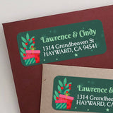 Christmas return address label with green background, red gift boxes, foliage and berries, personalized names and address – XOXOKristen