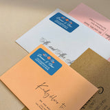 Blue background return address label featuring floral orange blossom with leafy details and custom white calligraphy - XOXOKristen