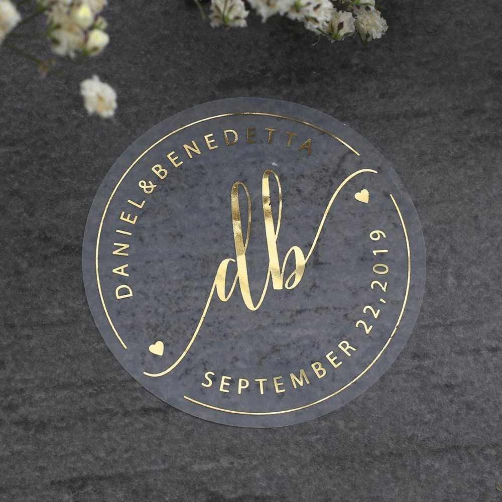 Custom wedding sticker with monogram initials and heart accents. Entirely personalized clear labels. 