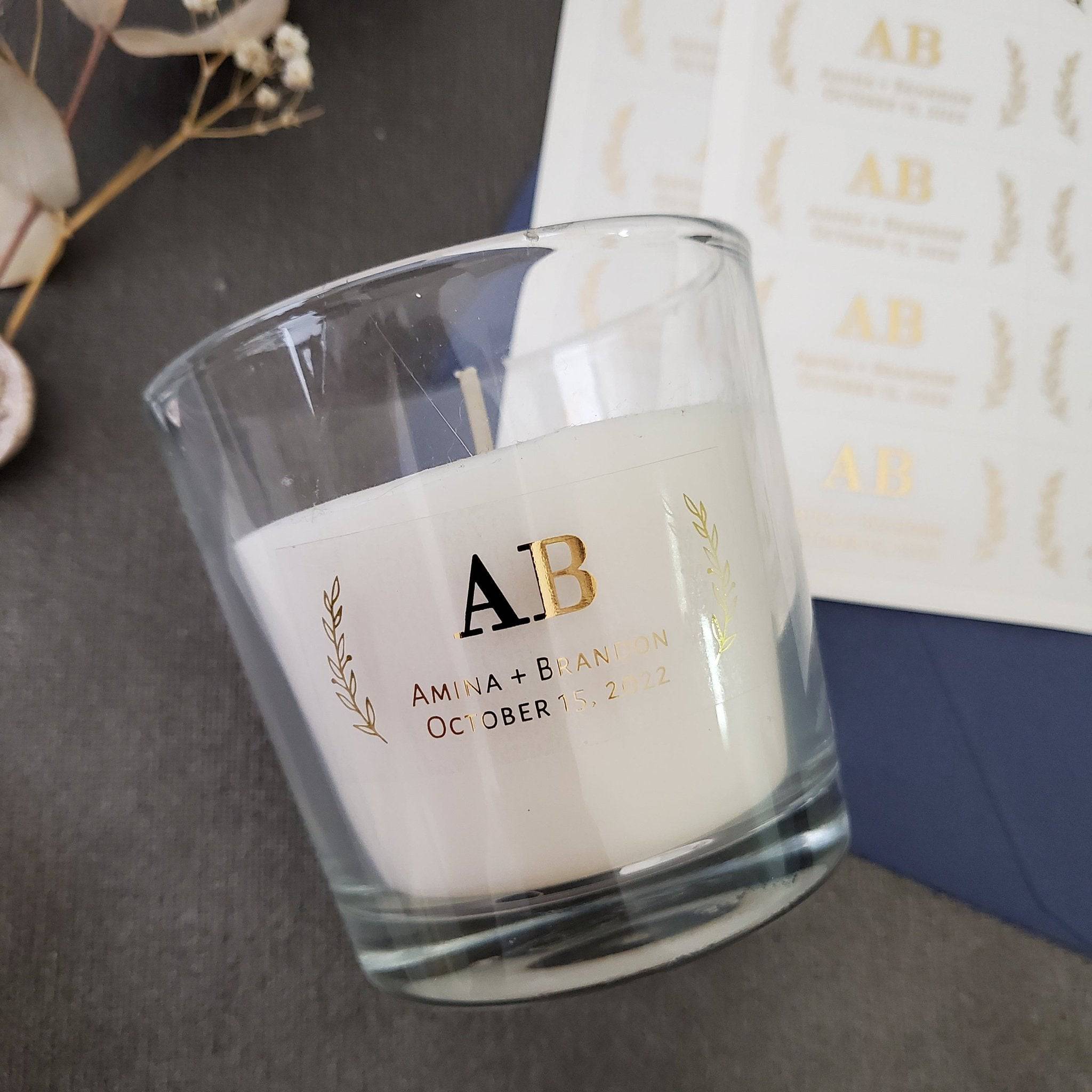 Small rectangular clear wedding favor stickers with gold foil print placed on candle - XOXOKristen