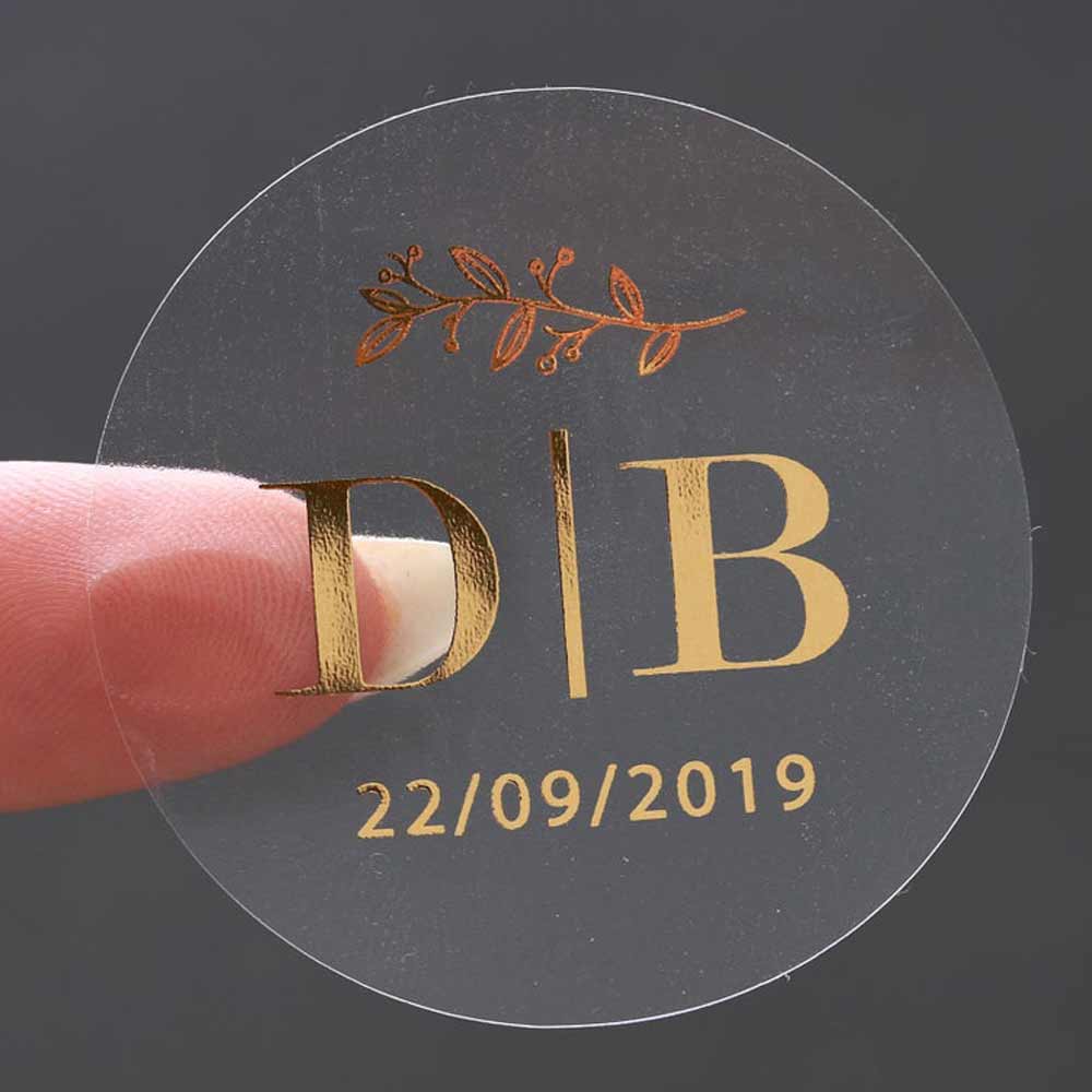 Custom wedding sticker with monogram initials and gold foiled lettering. Entirely personalized clear labels.  