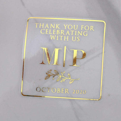 Custom gold foiled wedding stickers with monogram initials and floral design. Entirely personalized clear labels.