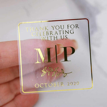 Custom gold foiled wedding stickers with monogram initials and floral design. Entirely personalized clear labels.