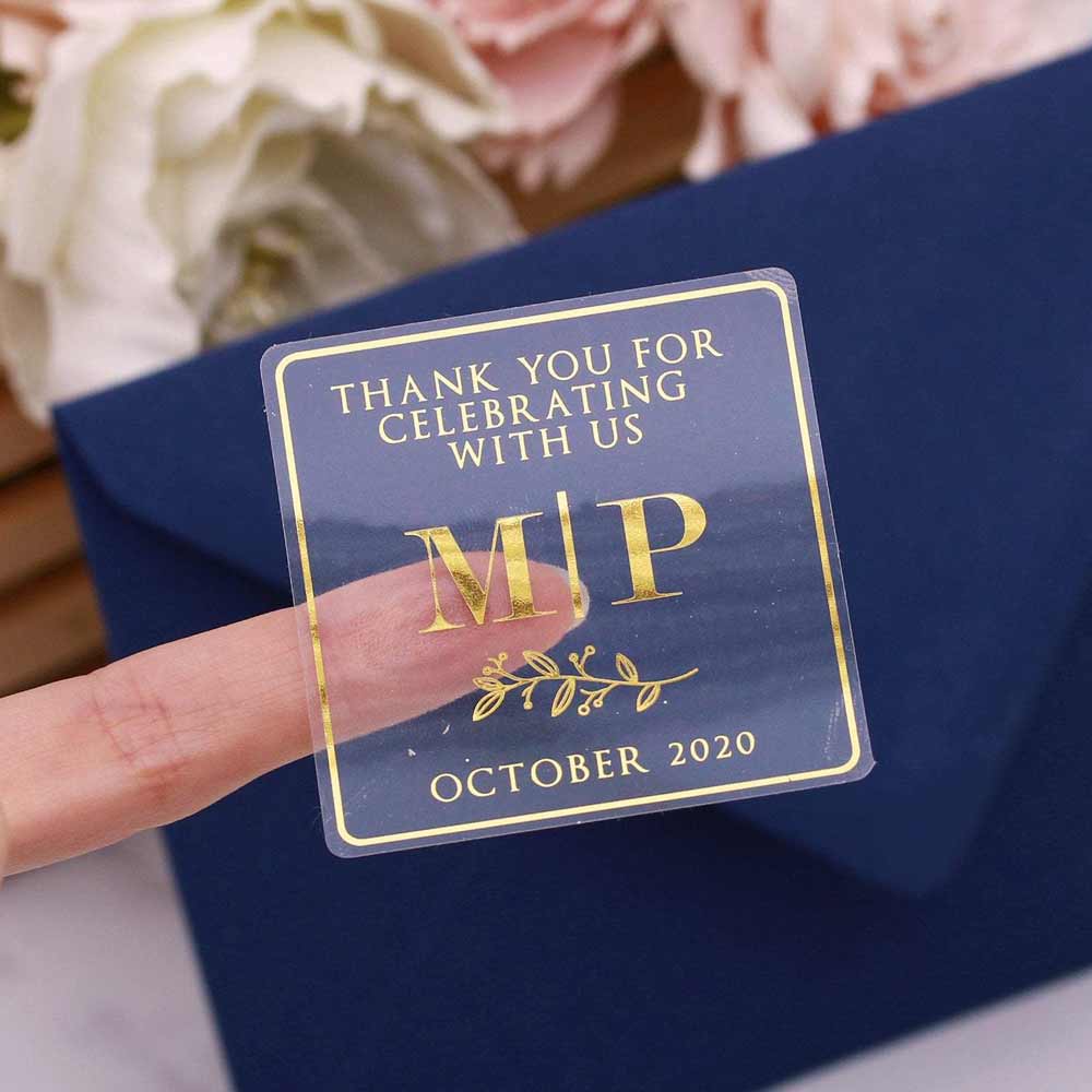 Custom gold foiled wedding stickers with monogram initials and floral design. Entirely personalized clear labels.