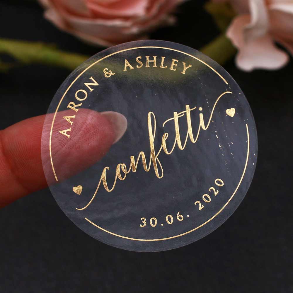 Custom gold foiled wedding confetti sticker with real gold foil lettering. Entirely personalized clear labels. 