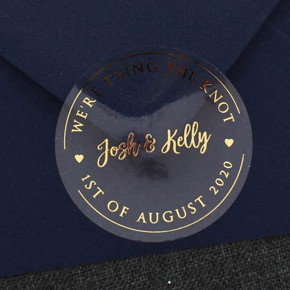 Custom wedding we are tying the knot sticker with real gold foiled lettering. Entirely personalized clear labels.