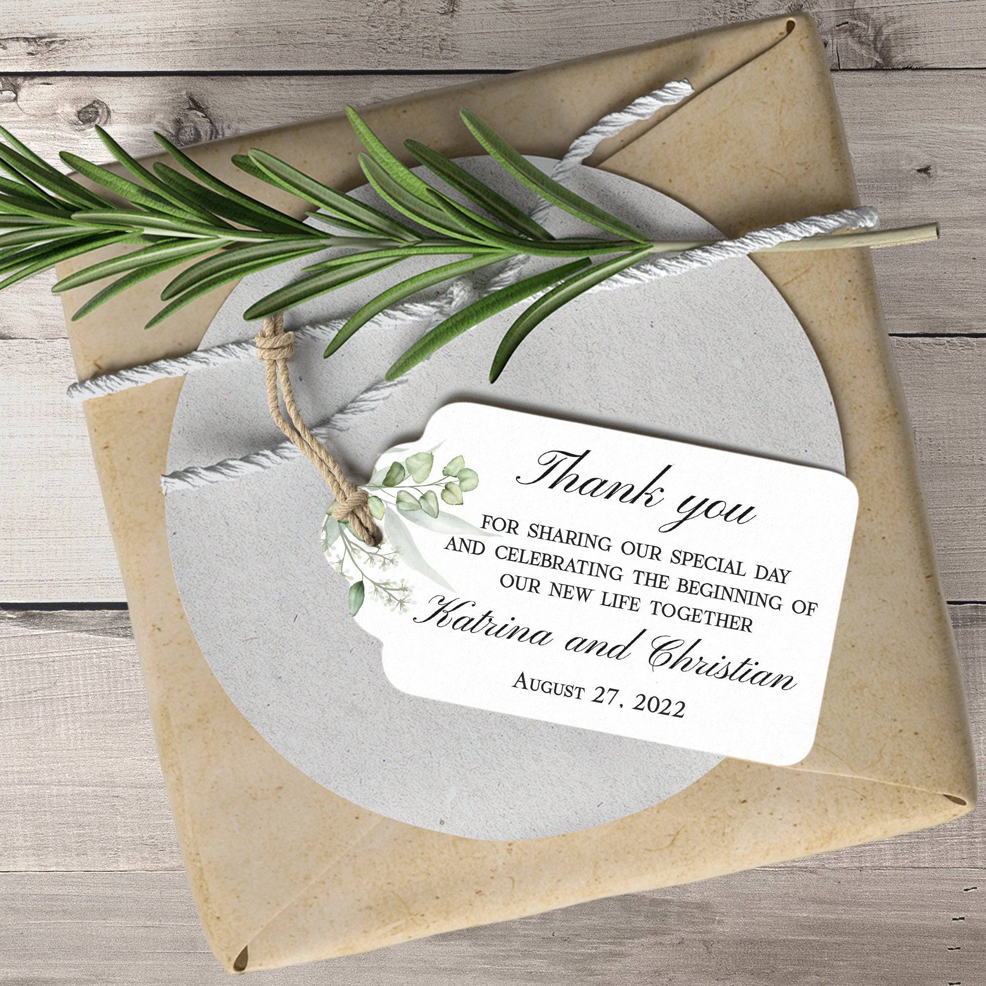 XOXOKristen Greenery Wedding Thank You Tag placed on soft beige fabric — minimalist botanical design, personalized and custom tag for weddings.